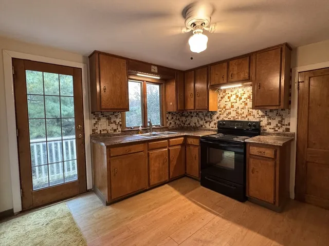 a kitchen with stainless steel appliances granite countertop a stove and a sink