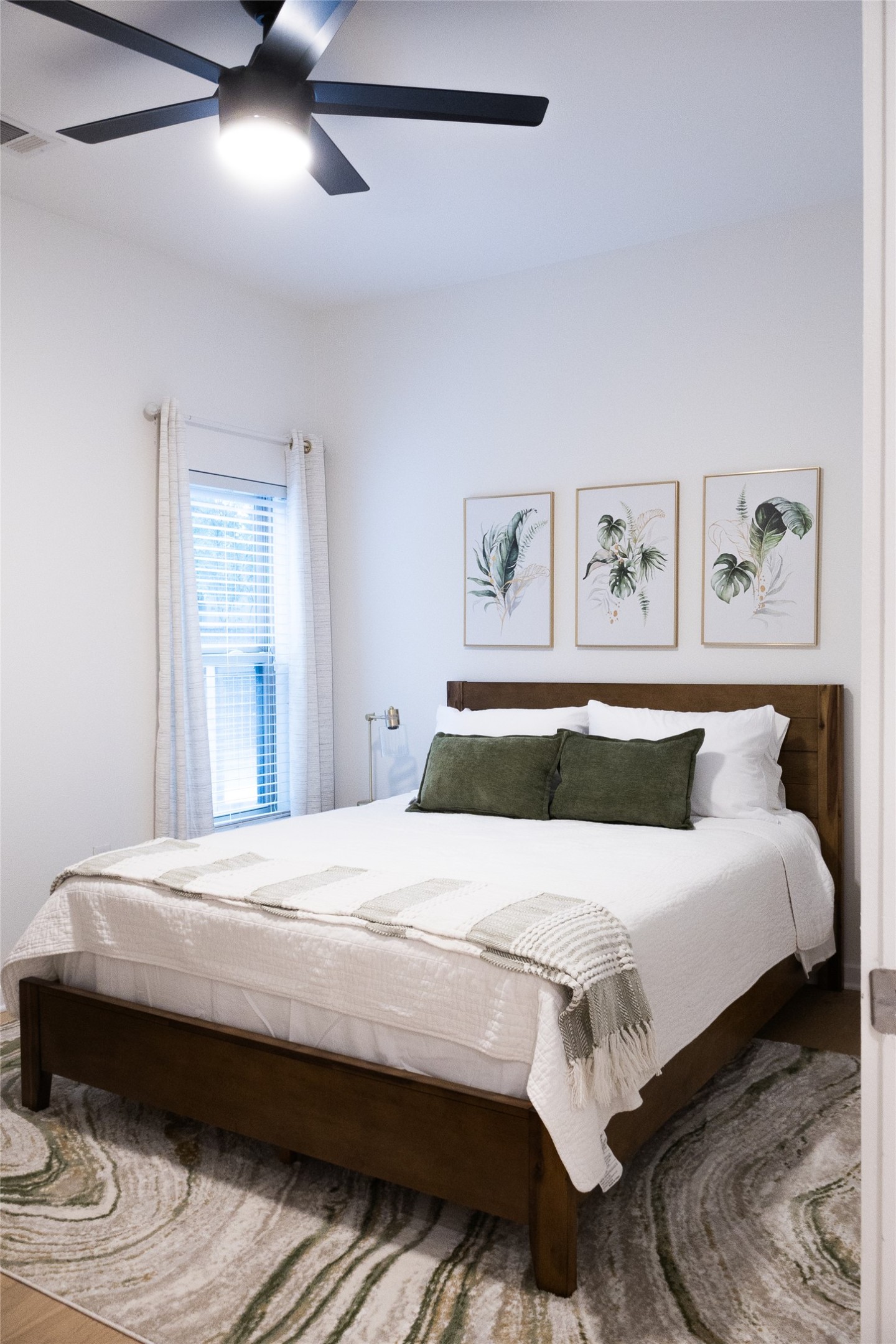 2505 Thornton Road, Unit 3108 Austin, TX 78704 - Photo 11 of 32 a bedroom with bed and paintings on the wall