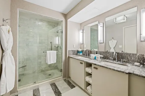 a bathroom with a shower sink and mirror