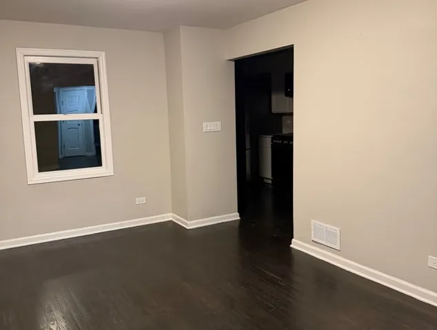 an empty room with wooden floor and closet