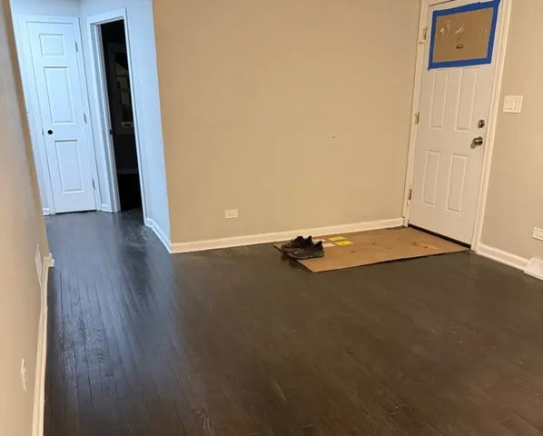 an empty room with wooden floor