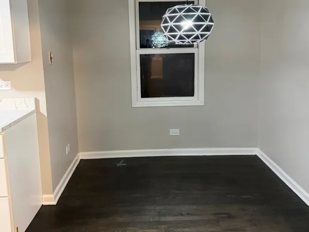 a view of a utility room with wooden floor