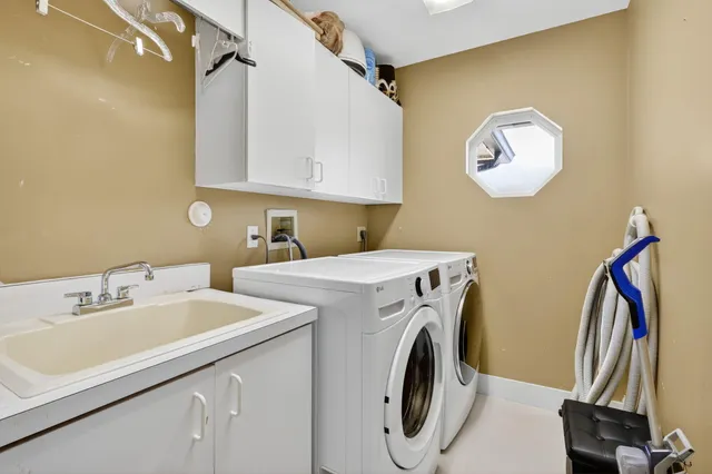 a kitchen with stainless steel appliances granite countertop a sink and a refrigerator
