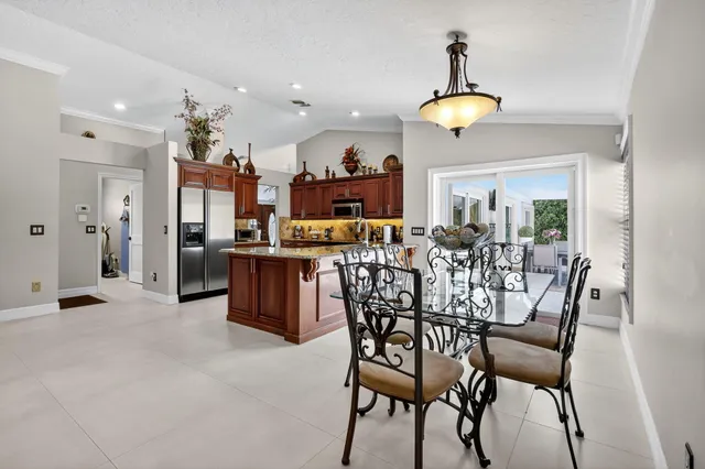 a kitchen with stainless steel appliances kitchen island granite countertop a stove and cabinets