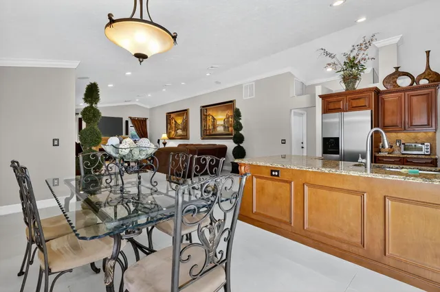 a bathroom with a granite countertop sink and a toilet