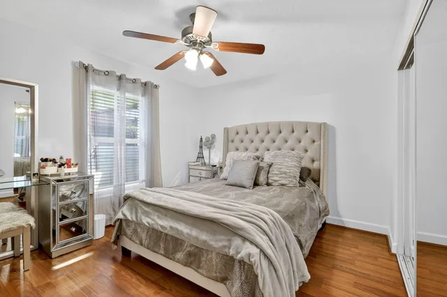 a dining room with furniture and a floor to ceiling window