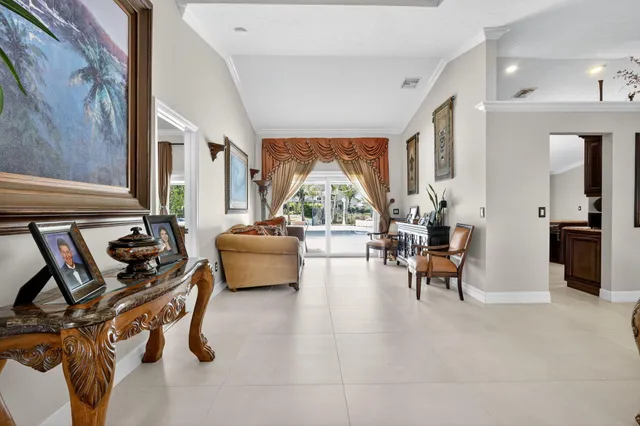 a living room with furniture and large windows