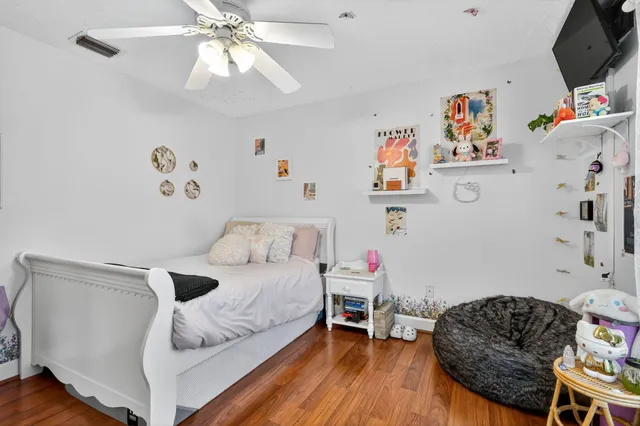 a view of a swimming pool with a table and chairs under a yard