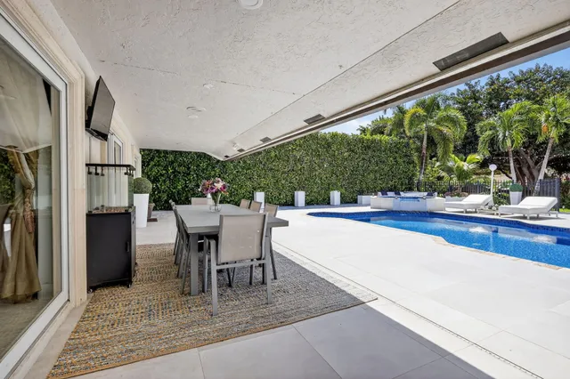 an aerial view of a house with a garden and lake view
