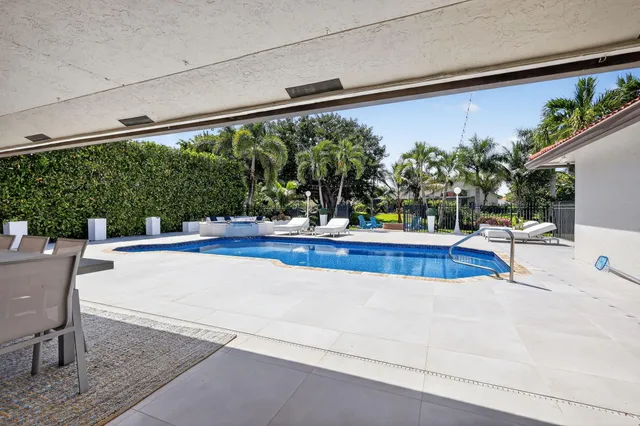 an aerial view of a house with a yard basket ball court and outdoor seating