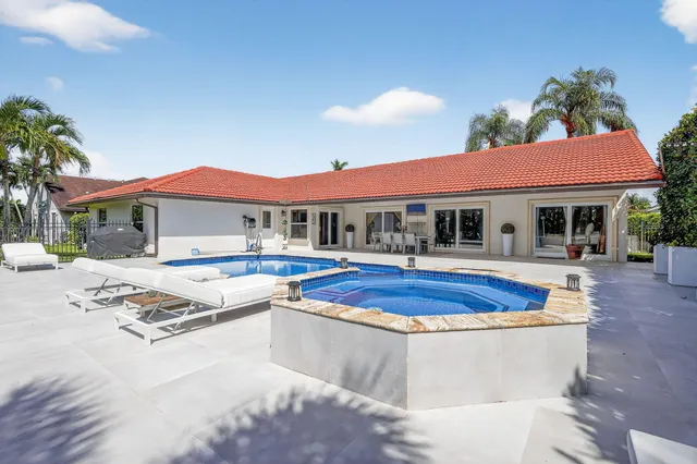 a view of a dining room with furniture and chandelier fan