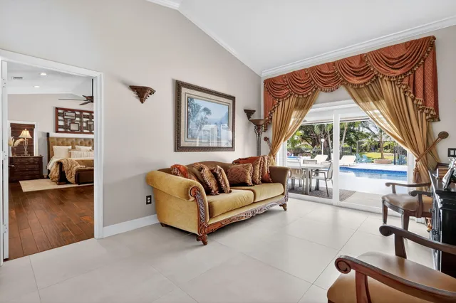 a bedroom with furniture and a large window