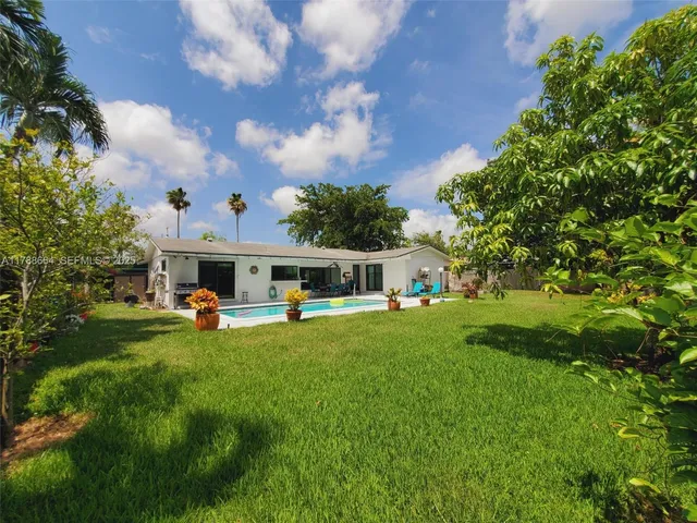 a front view of house with yard and green space
