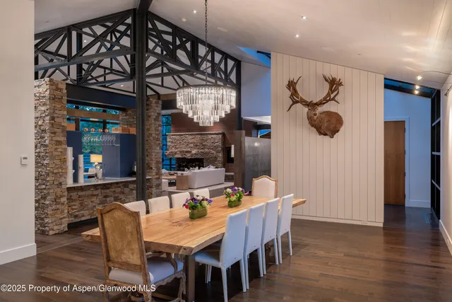 a living room with furniture a fireplace and a large window