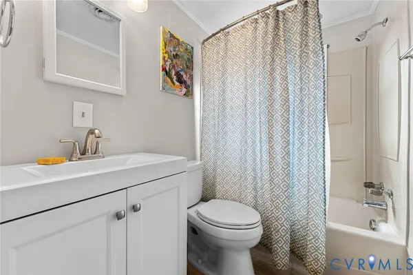 a bathroom with a sink a toilet and shower curtain