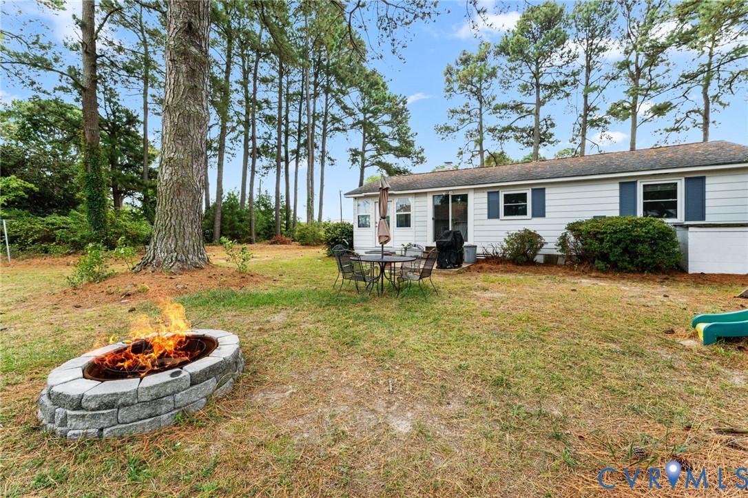 1061 Timberneck Road Deltaville, VA 23043 - Photo 24 of 28 a backyard of a house with yard and outdoor seating