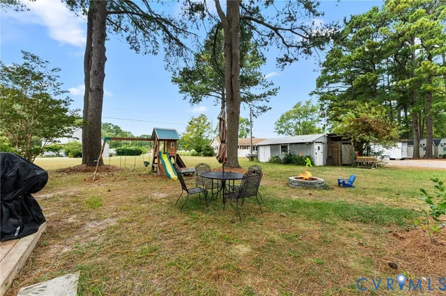 a view of a house with backyard porch and sitting area