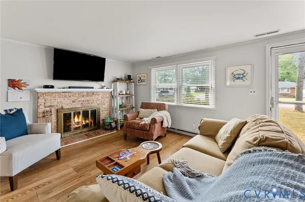 a living room with furniture fireplace and flat screen tv