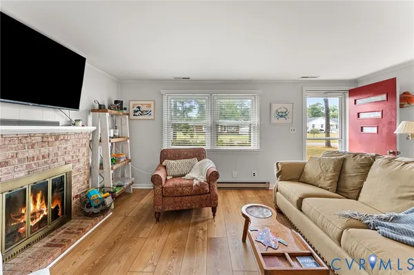 a living room with furniture fireplace and flat screen tv