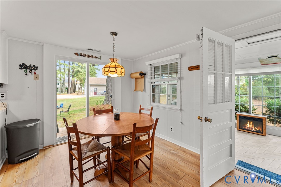 1061 Timberneck Road Deltaville, VA 23043 - Photo 8 of 28 a view of a dining room with furniture window and wooden floor