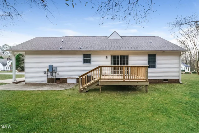 a view of a house with a yard and deck