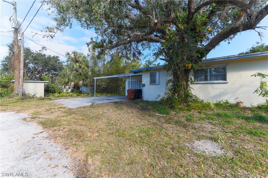 2914 Sunset Road Fort Myers, FL 33901 - Photo 3 of 28 a backyard of a house with plants and large tree
