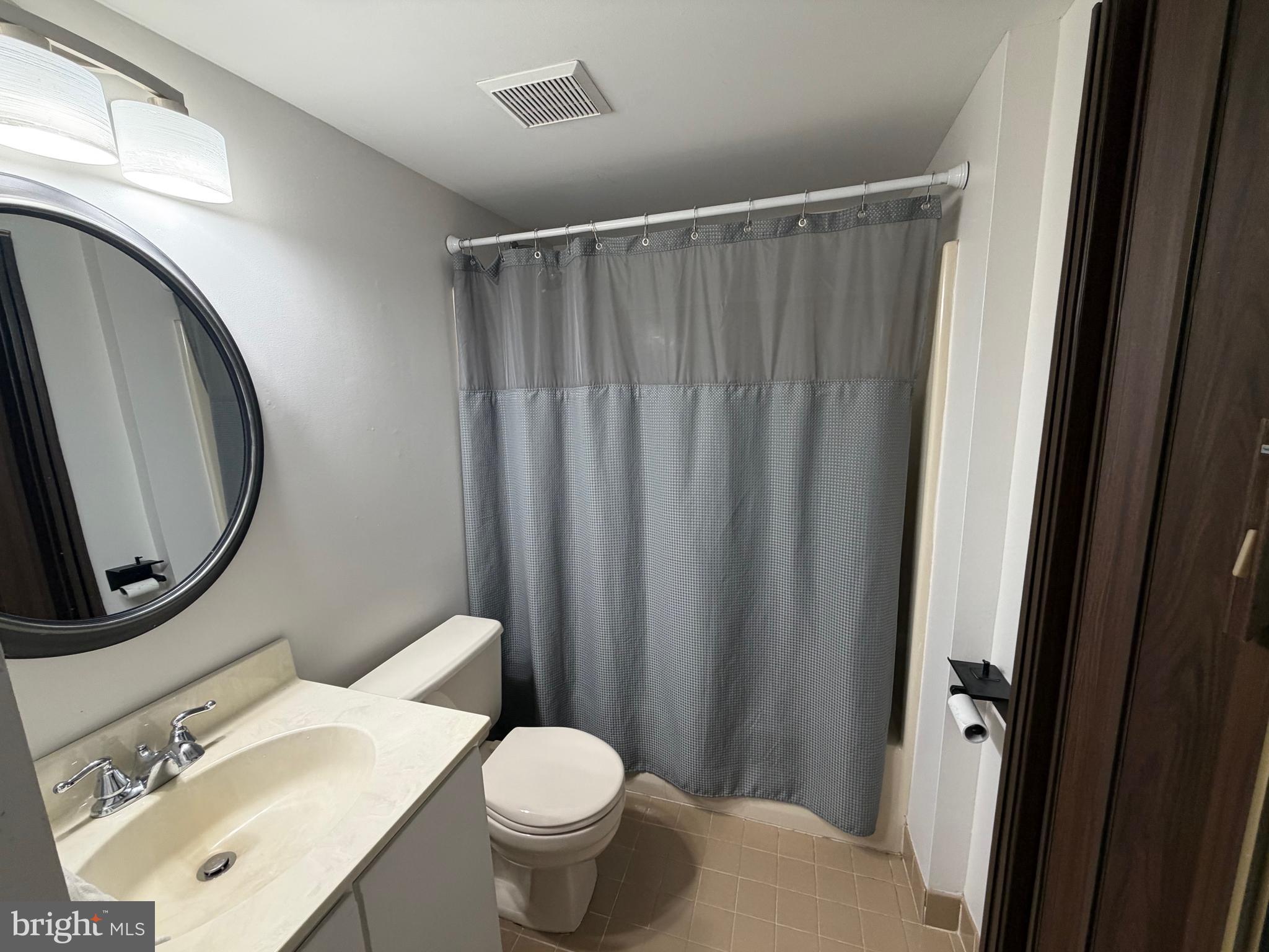 106 Pinewood Drive Hamilton, NJ 08690 - Photo 11 of 12 a bathroom with a sink a toilet and a mirror