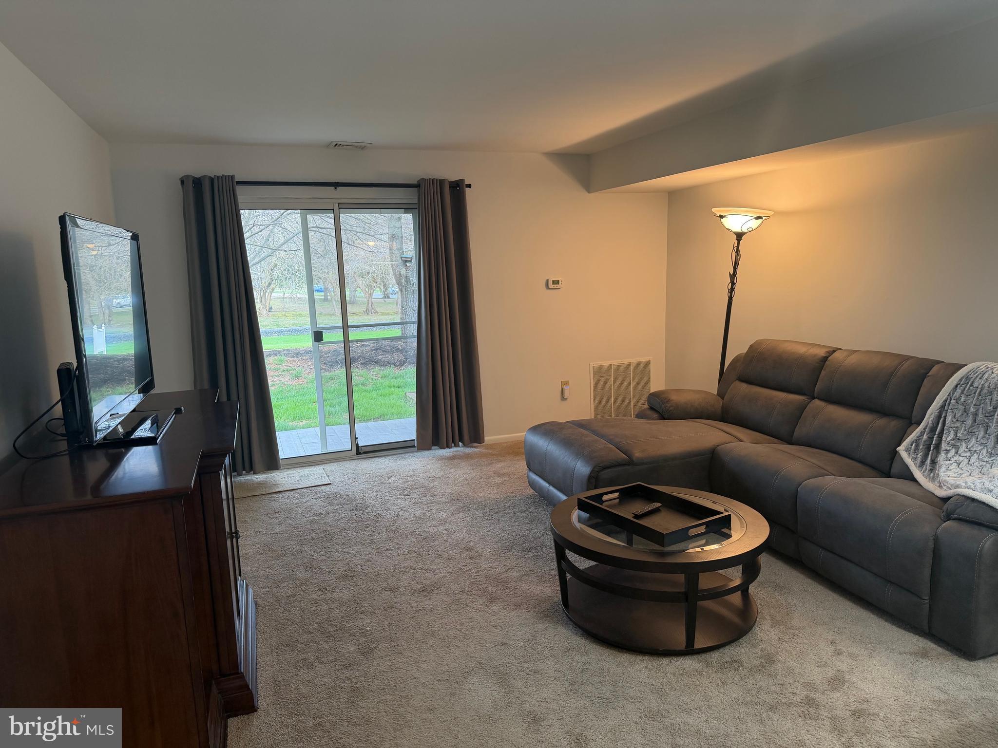 106 Pinewood Drive Hamilton, NJ 08690 - Photo 2 of 12 a living room with furniture and a flat screen tv