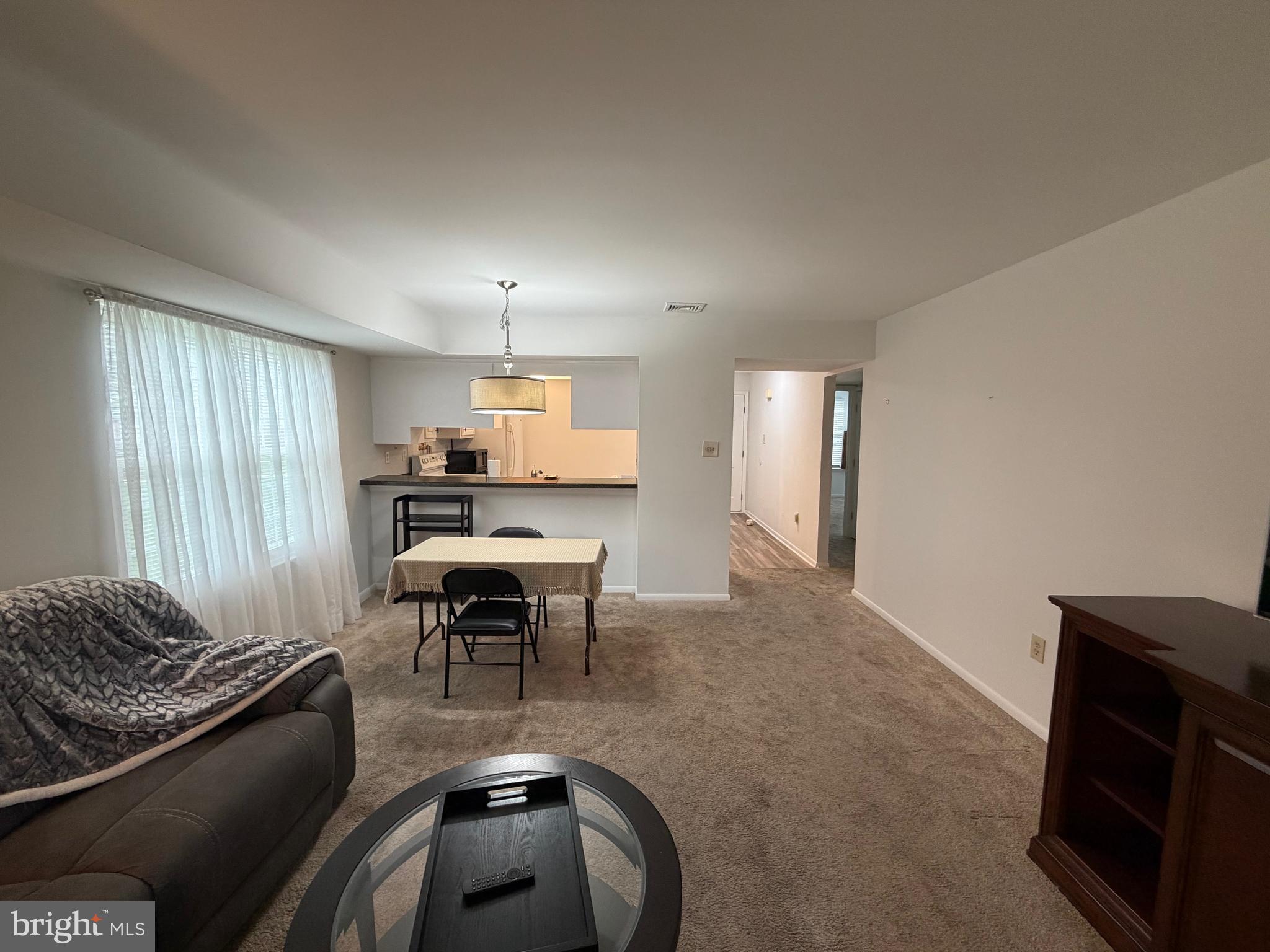 106 Pinewood Drive Hamilton, NJ 08690 - Photo 3 of 12 a living room with furniture and a table