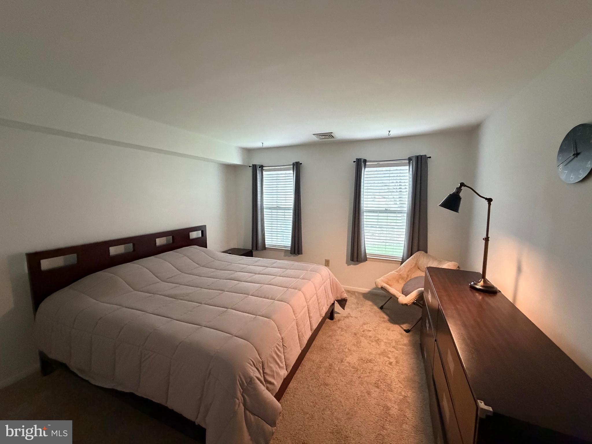 106 Pinewood Drive Hamilton, NJ 08690 - Photo 7 of 12 a bed sitting in a bedroom and wooden floor
