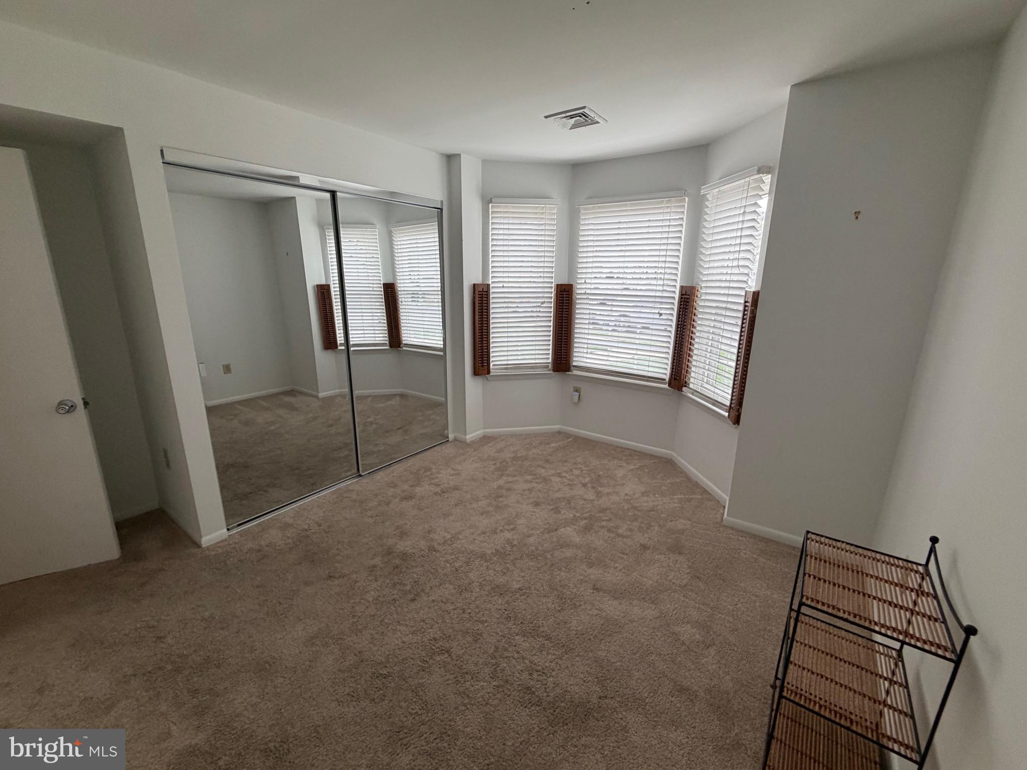 106 Pinewood Drive Hamilton, NJ 08690 - Photo 10 of 12 a view of empty room with wooden floor and fan