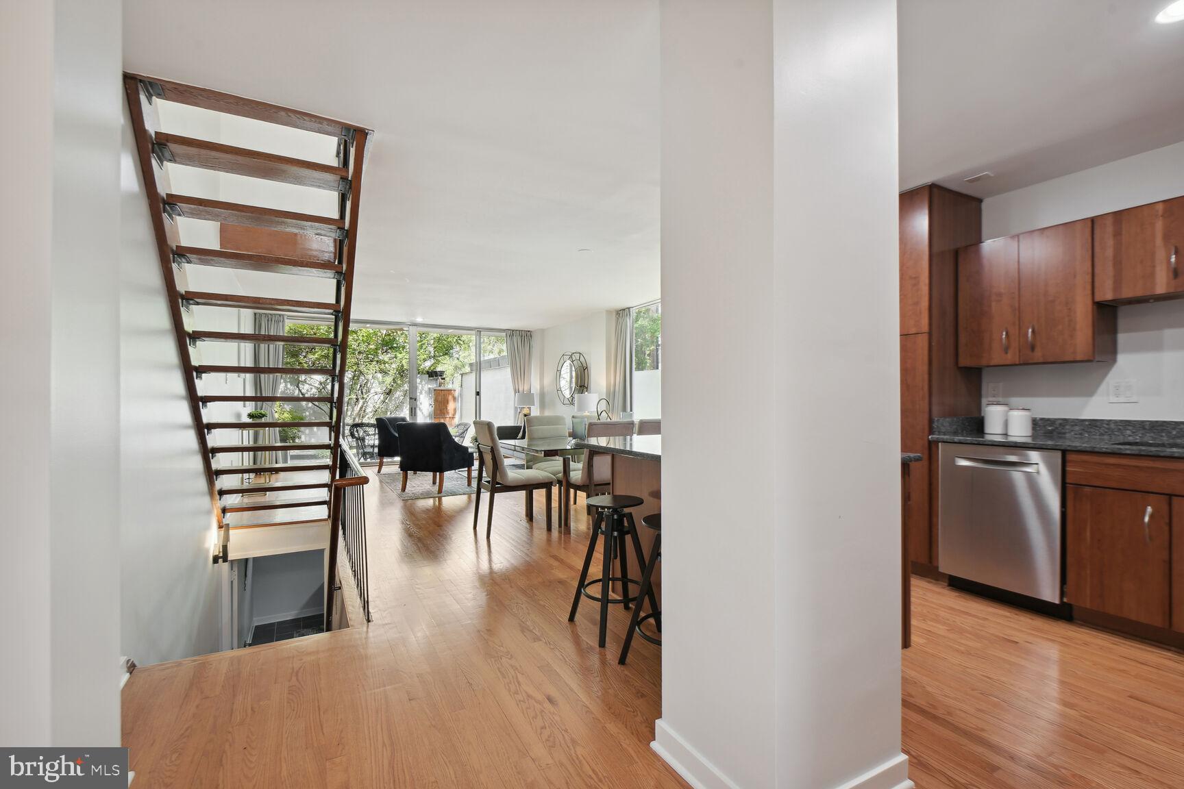 a view of a kitchen with furniture and wooden floor