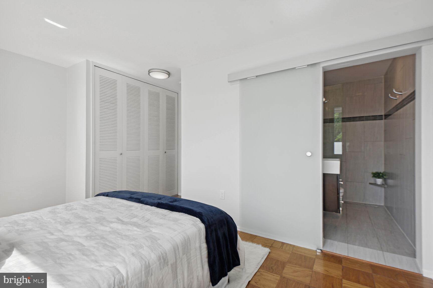 345 O Street Southwest Washington, DC 20024 - Photo 13 of 46 a bedroom with a bed and a view of bathroom