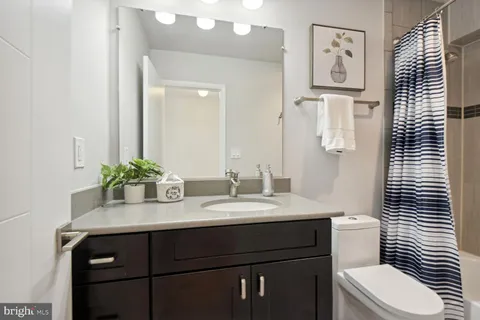a bathroom with a sink a toilet and mirror