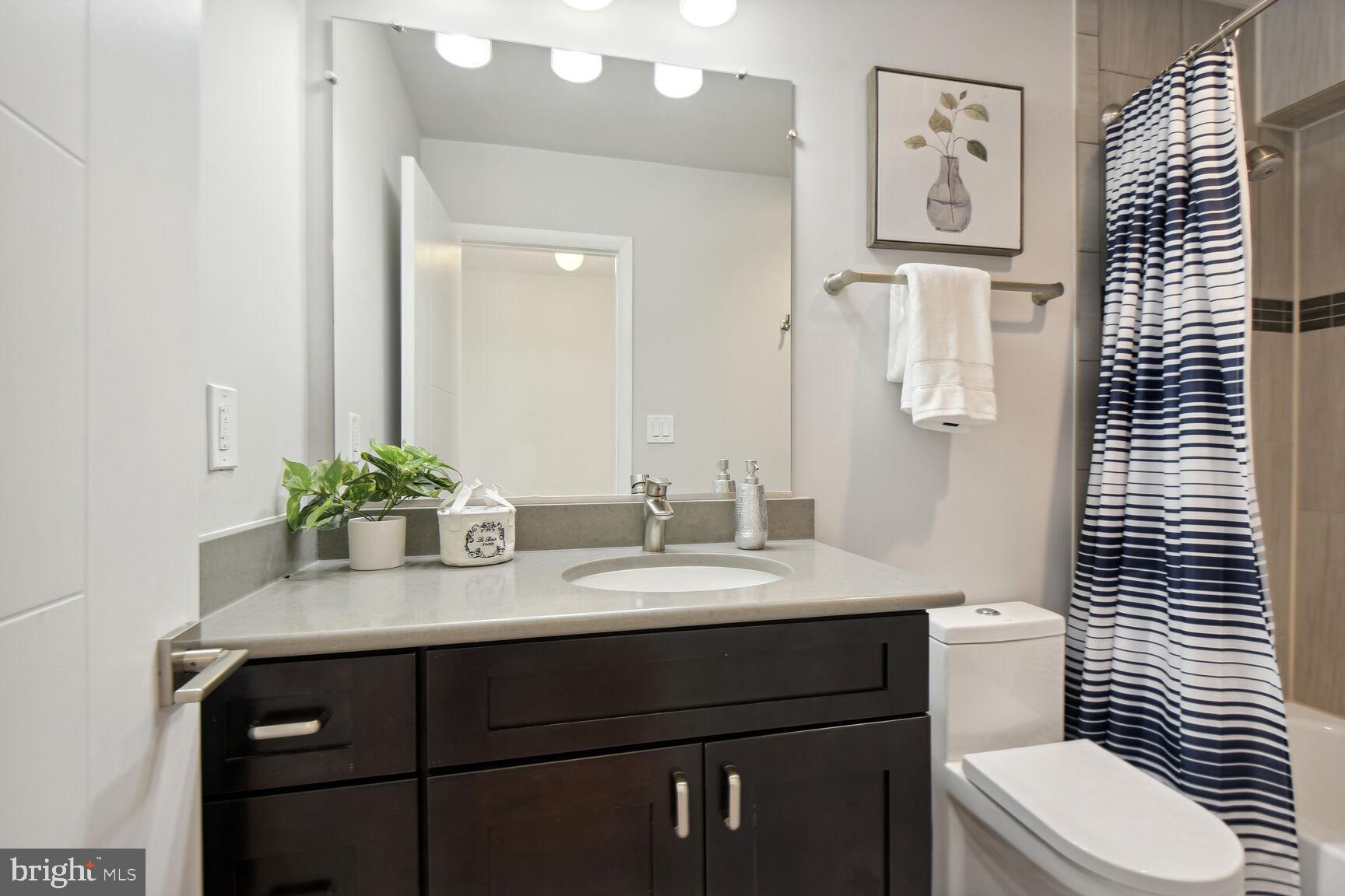 345 O Street Southwest Washington, DC 20024 - Photo 17 of 46 a bathroom with a sink a toilet and mirror