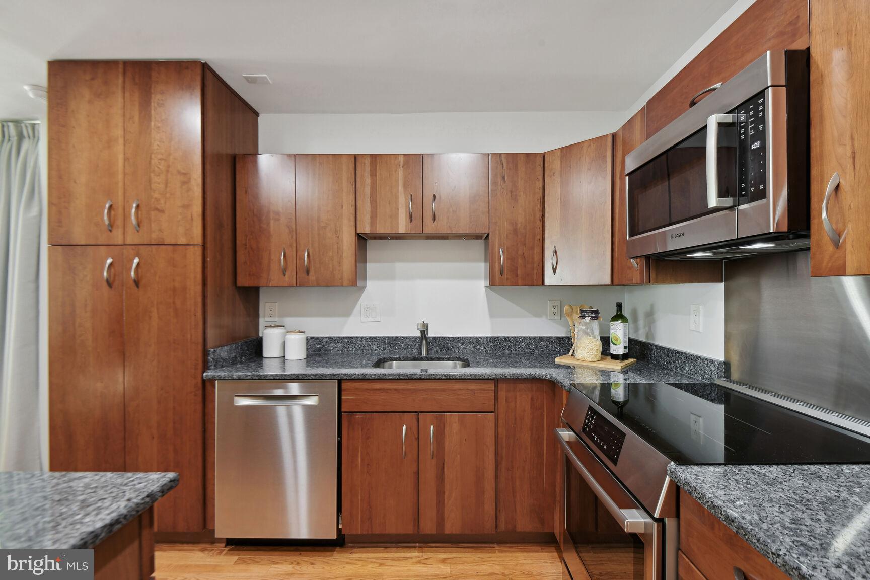 345 O Street Southwest Washington, DC 20024 - Photo 2 of 46 a kitchen with granite countertop a sink stove and refrigerator