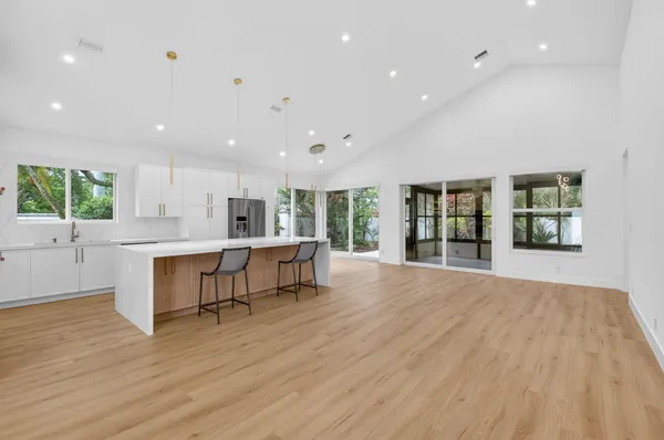a view of kitchen with furniture and wooden floor