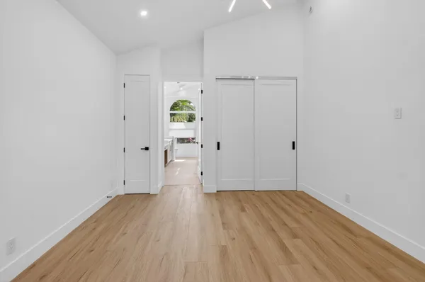 a view of an empty room with wooden floor