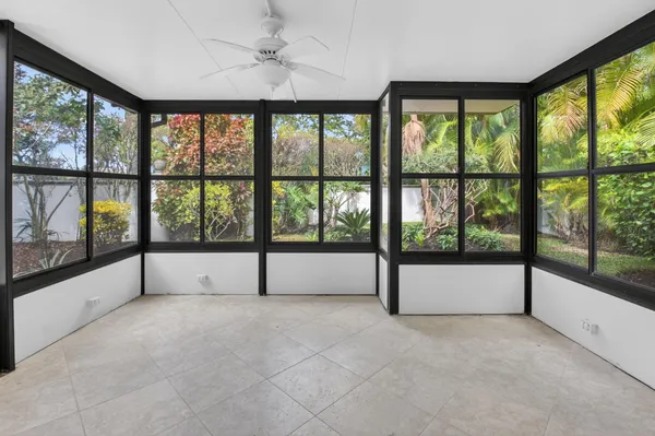 a view of an empty room with a window and balcony