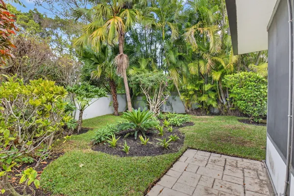 a view of a house with potted plants