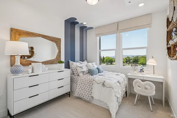 a bedroom with a large bed and a window