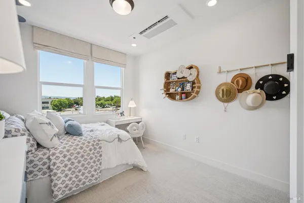 a bedroom with furniture and a window