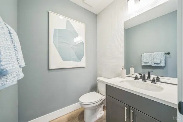 a bathroom with a sink toilet and a mirror