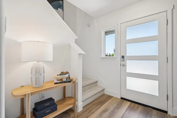 a view of an entryway with wooden floor