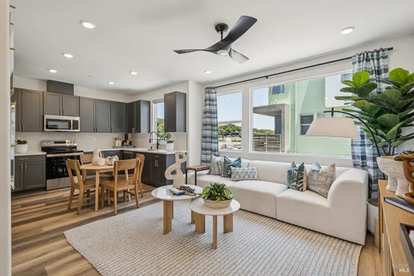 a living room with furniture kitchen and a table