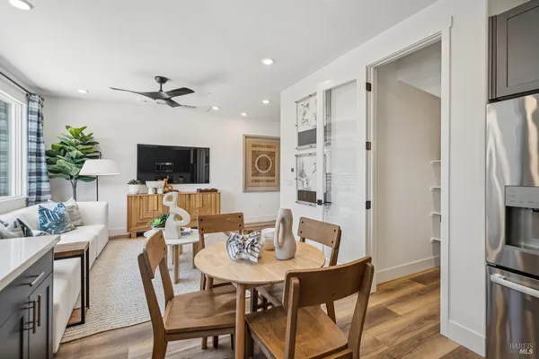 a view of a dining room with furniture and a flat screen tv