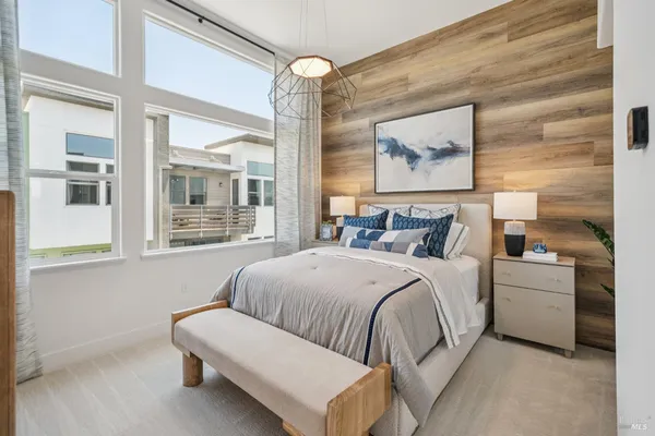 a bedroom with a bed and a painting on the wall