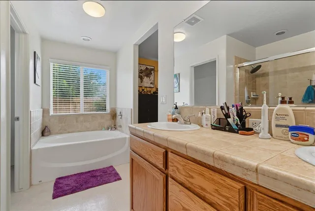 a bathroom with a tub sink and mirror