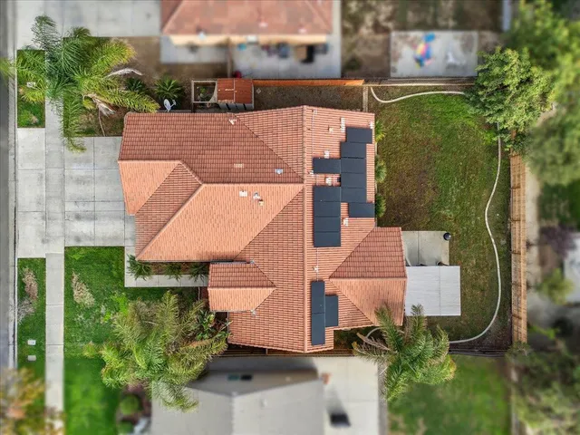an aerial view of a house with a yard