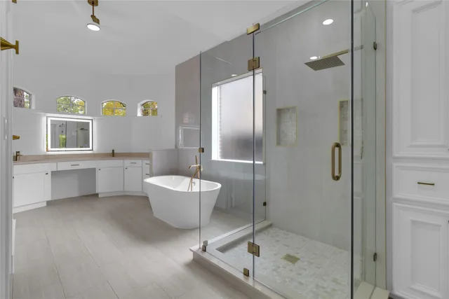an open kitchen with white cabinets and stainless steel appliances